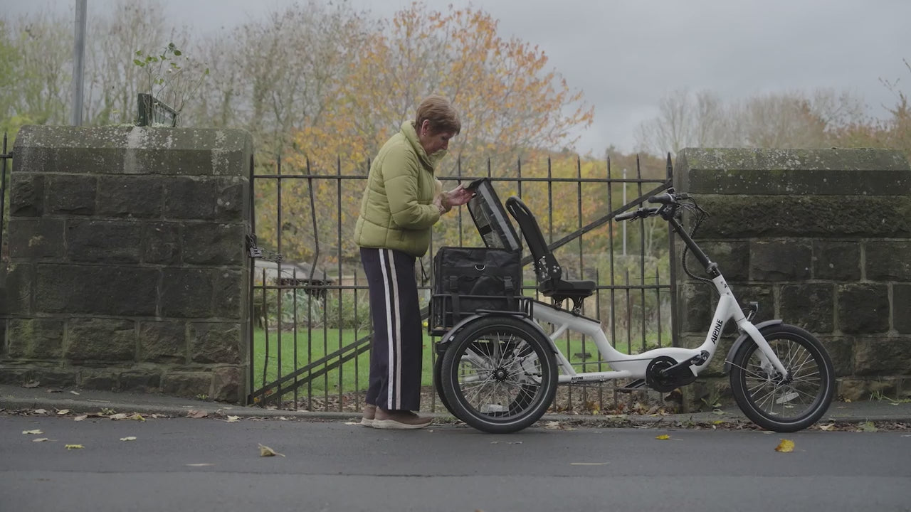 Load video: A video of a lady using her electric tricycle to get around the village.